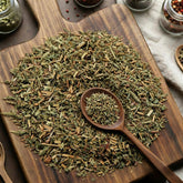 Dry cut and sifted Agrimony herb pieces on a wooden surface.