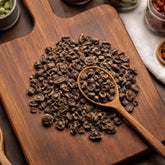 Whole Alfalfa seeds (Medicago sativa) on a walnut board with a wooden spoon - CanadaVitalife