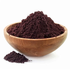 Heaped bowl of dark purple Alkanet root powder, used as a natural dye and herbal remedy, in a wooden bowl on a white background - Canada Vitalife