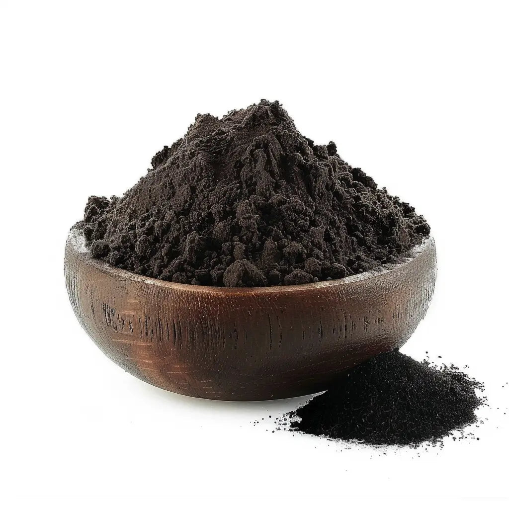 Bowl of fine black activated charcoal powder made from coconut shells, on a white background - Canada Vitalife