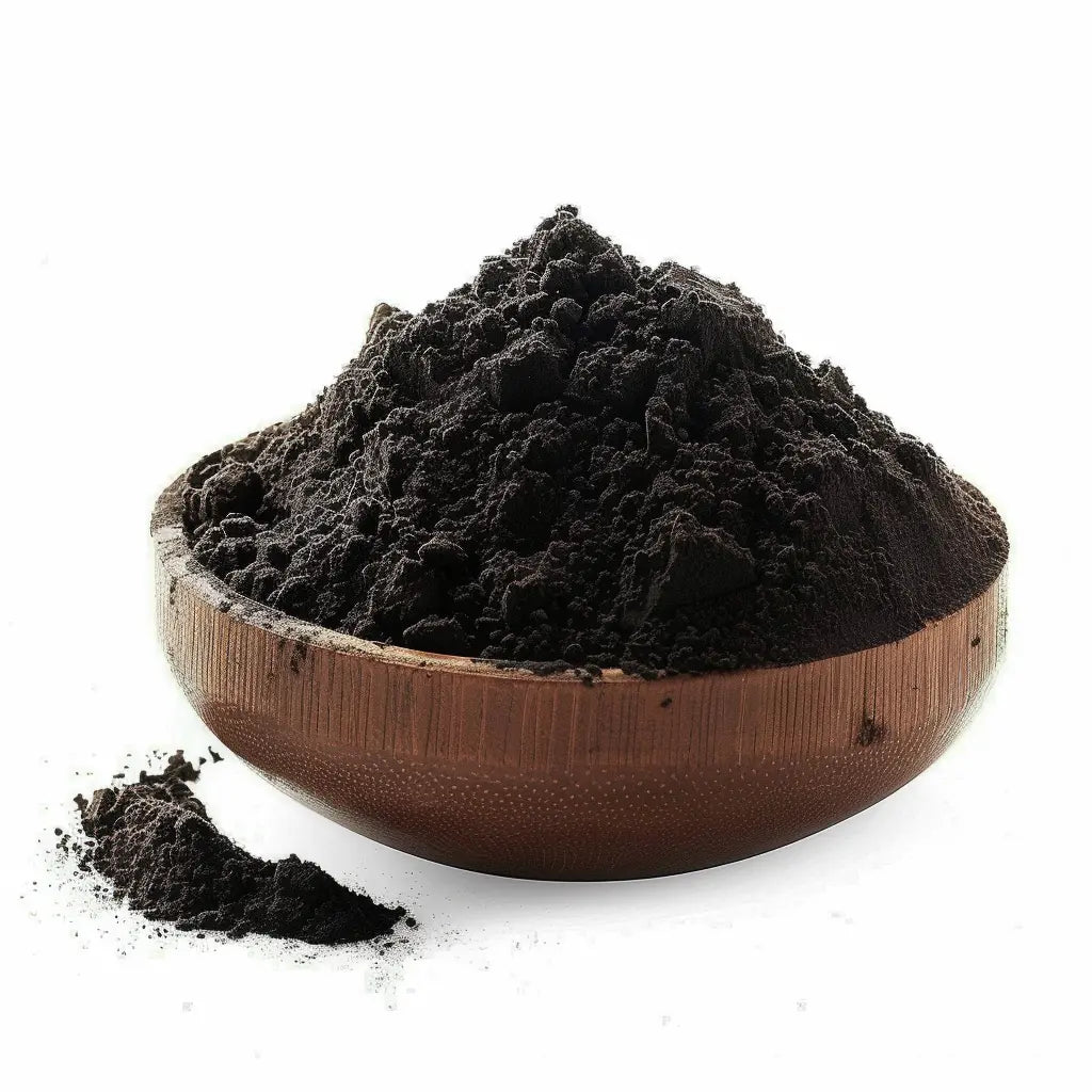 Bowl of fine black activated charcoal powder made from hardwood, on a white background - Canada Vitalife