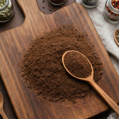 Finely milled brown bladderwrack powder on a wooden surface for botanical and personal care use.
