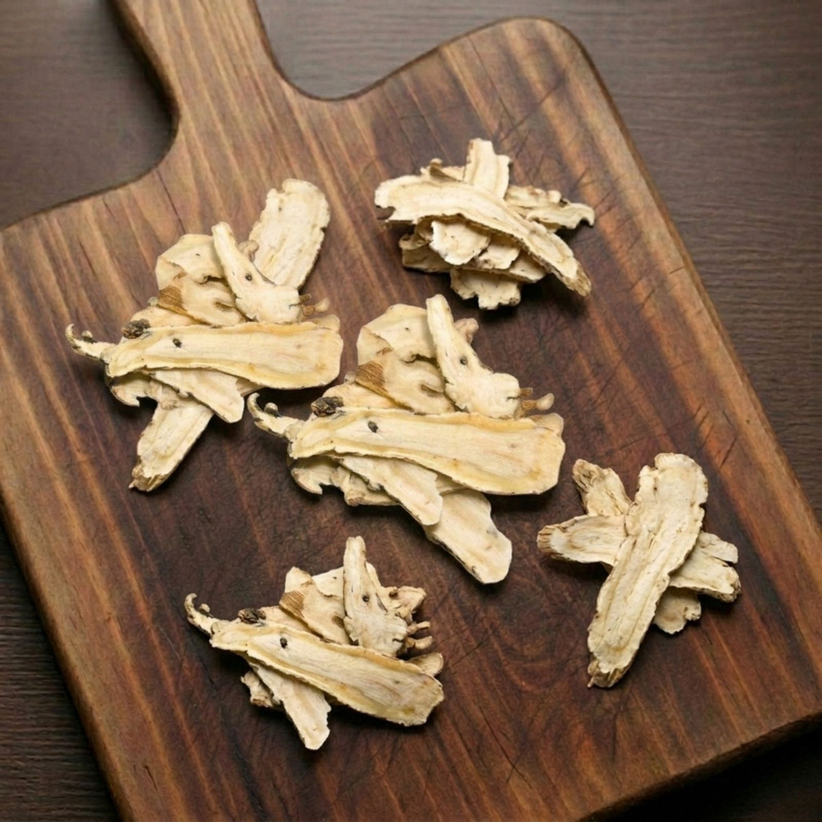 Dry slices of Dong Quai root (Angelica sinensis) for traditional botanical infusions.