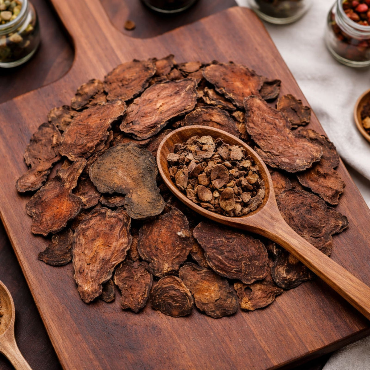 Dried Fo-ti root slices displayed on a rustic wooden board for traditional herbal tea.