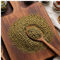 Dry cut and sifted green papaya leaves on a wooden surface