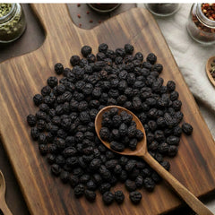 Whole dark dried Saw Palmetto berries showing a wrinkled texture and natural oils - Canadavitalife